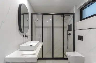 a white bathroom with a shower and a sink at Orquídea Apartment by Holiday Rental Madeira in Funchal