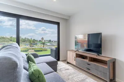 a living room with a gray couch and a table at Orquídea Apartment by Holiday Rental Madeira in Funchal