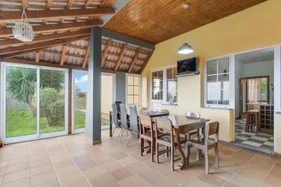 a dining room with a table and chairs at Porto Moniz Yellow House in Porto Moniz