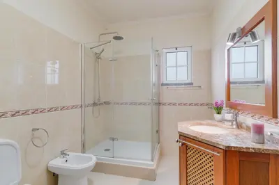 a bathroom with a shower and a toilet and a sink at Porto Moniz Yellow House in Porto Moniz