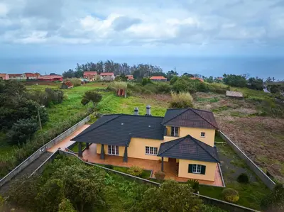 an aerial view of a house with a roof at Porto Moniz Yellow House in Porto Moniz