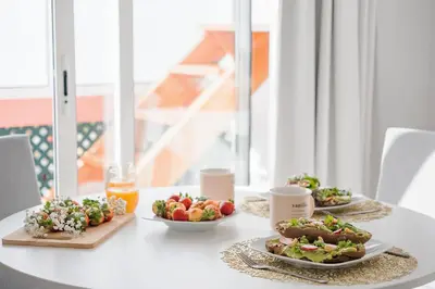a table with three plates of food on it at City Centre Retreat by Homie in Funchal