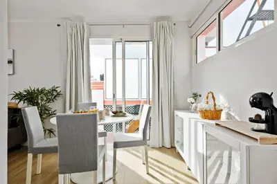 a kitchen and dining room with a white table and chairs at City Centre Retreat by Homie in Funchal