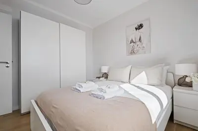 a white bedroom with a bed with towels on it at City Centre Retreat by Homie in Funchal