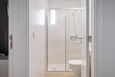 a bathroom with a shower and a toilet at City Centre Retreat by Homie in Funchal