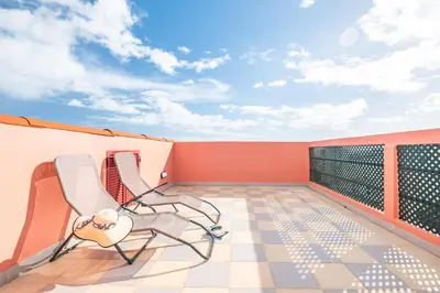 a balcony with two chairs on a roof at City Centre Retreat by Homie in Funchal