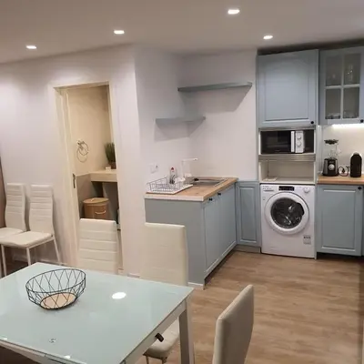 a kitchen with a table and a washing machine at Center Marina View Brown Studio in Funchal