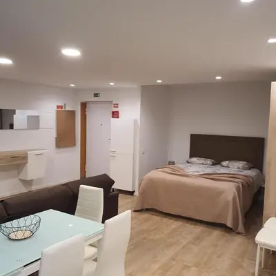 a bedroom with a bed and a table and chairs at Center Marina View Brown Studio in Funchal