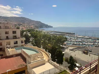 a view of a city with a marina and a pool at Center Marina view Blue Studio in Funchal