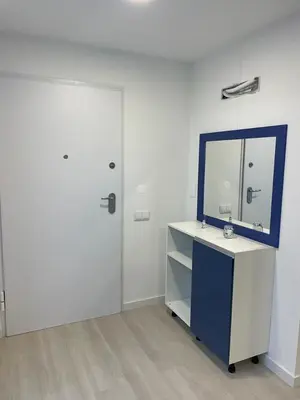 a white room with a mirror and a desk with a sink at Center Marina view Blue Studio in Funchal