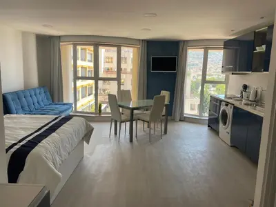 a hotel room with a bed and a table and chairs at Center Marina view Blue Studio in Funchal