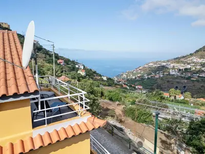 a view from the roof of a yellow house with a hill at Petit Campanário in Campanário