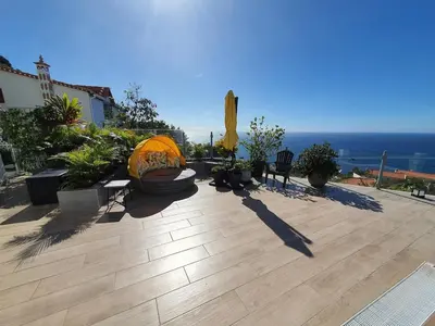 a large patio with a view of the ocean at Villa Palmera Sea View in Arco da Calheta