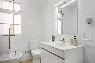 a white bathroom with a sink and a toilet at Horizon Glow in Calheta