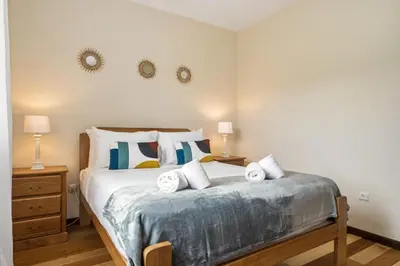 a bedroom with a bed with towels on it at Horizon Glow in Calheta