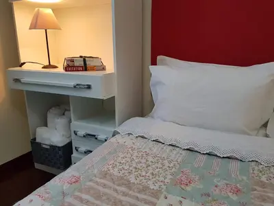 a bedroom with a bed and a night stand with a lamp at Villa Cosy Nook in Funchal