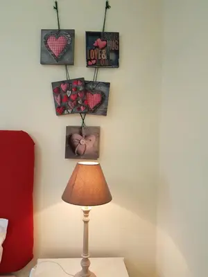 a lamp on a table in a room with hearts on the wall at Villa Cosy Nook in Funchal