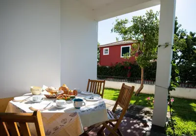 a table with a plate of food on a patio at Villa Cosy Nook in Funchal