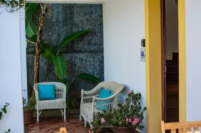 a patio with two chairs and plants at Villa Cosy Nook in Funchal