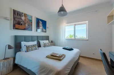 a bedroom with a large bed with towels on it at Casa Rosa1 at Boavista Resort in Lagos