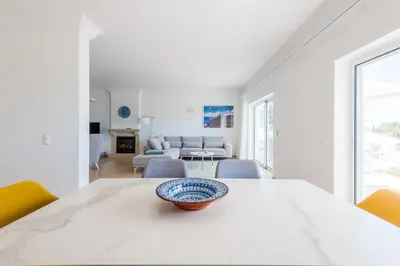 a white dining room with a table with a bowl on it at Casa Rosa1 at Boavista Resort in Lagos