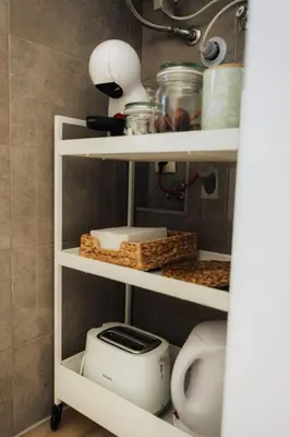 a kitchen shelf with a toaster and other kitchen items at Casa Calma I in Luz
