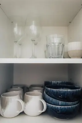 a shelf with plates and cups and bowls on it at Casa Calma I in Luz