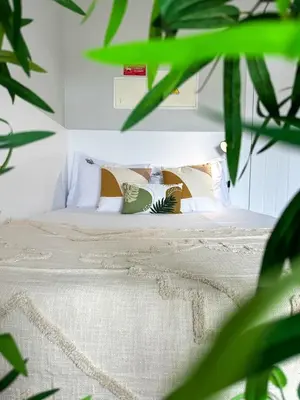 a bedroom with a bed with white sheets and pillows at Santa Luzia's Pearl II D - Studio in Funchal