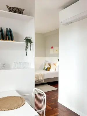 a bedroom with a bed and a room with white walls at Santa Luzia's Pearl II D - Studio in Funchal