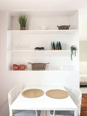 a white dining room table with white shelves at Santa Luzia's Pearl II D - Studio in Funchal
