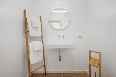 a bathroom with a sink and a mirror at VIRA by KAAMAH in Estreito de Câmara de Lobos