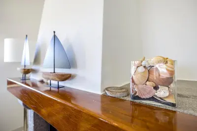 a wooden table with a vase of shells on it at Spacious villa with sea view and heated pool - Luz - Casa Amizade in Luz