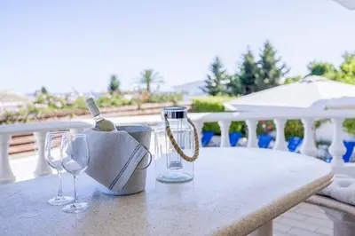 a table with two wine glasses and a bottle at Spacious villa with sea view and heated pool - Luz - Casa Amizade in Luz
