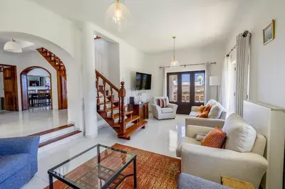 a living room with couches and a glass table at Spacious villa with sea view and heated pool - Luz - Casa Amizade in Luz
