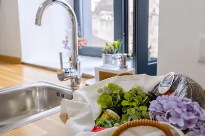 a basket of flowers sitting on a counter next to a sink at Vila Sun House A in Calheta