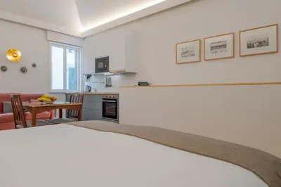 a kitchen and a living room with a table at Studio 118 in Funchal