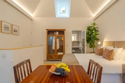 a bedroom with a bed and a table with a bowl of fruit at Studio 118 in Funchal