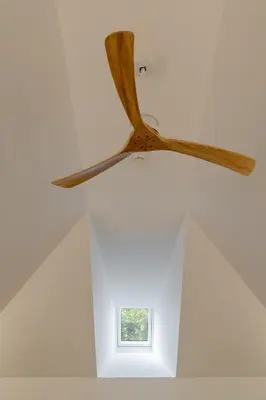 a ceiling fan in a room with a window at Studio 118 in Funchal