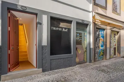 a store front with a sign on the side of a building at Studio 118 in Funchal