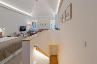 a bedroom with a staircase leading up to a bed at Studio 118 in Funchal