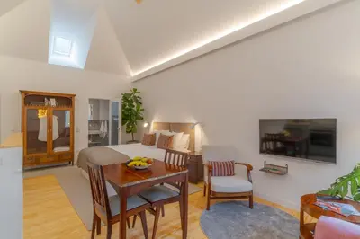 a living room with a orange couch and a table at Studio 118 in Funchal