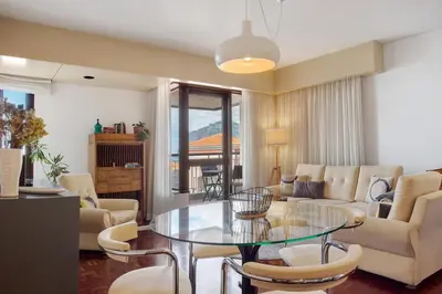 a living room with a glass table and chairs at Vista Formosa in Funchal