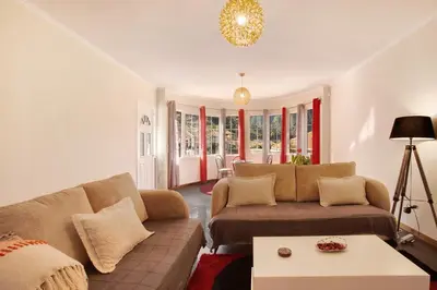 a living room with a couch and a table at Cristina Grand in São Vicente