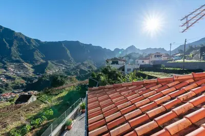 a view from the roof of a house with mountains in the background at Cristina Grand in São Vicente