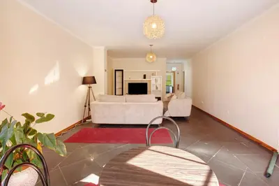 a living room with a white couch and a living room at Cristina Grand in São Vicente