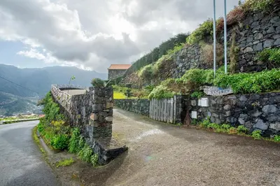 a stone wall on the side of a road at Refugio Da Xamusca in São Vicente