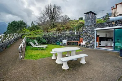 a white picnic table and benches in a yard at Refugio Da Xamusca in São Vicente