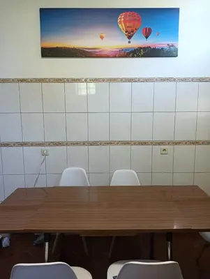 a conference room with a wooden table and chairs at Palm Comfort in São Vicente