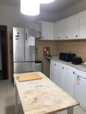 a kitchen with a refrigerator and a wooden counter top at Casa Dona Teresa in Santa Cruz