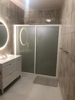 a bathroom with a shower and a sink and a mirror at Casa Dona Teresa in Santa Cruz